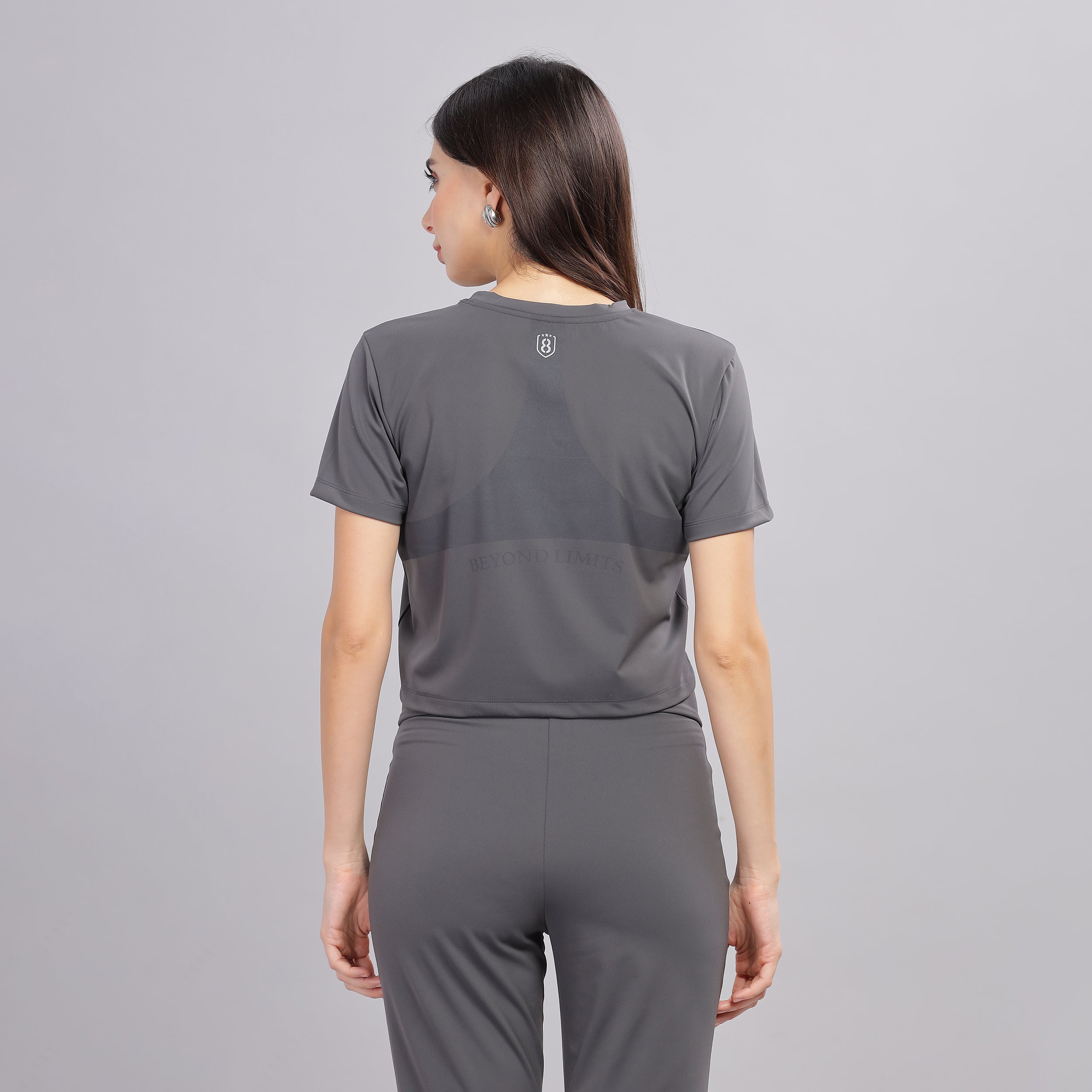 Back view of dark grey sweat-wicking jogger set for women.