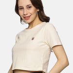 Front view of women’s beige spandex crop top, featuring a snug fit and soft cotton blend fabric.