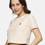 Front view of women’s beige spandex crop top, featuring a snug fit and soft cotton blend fabric.