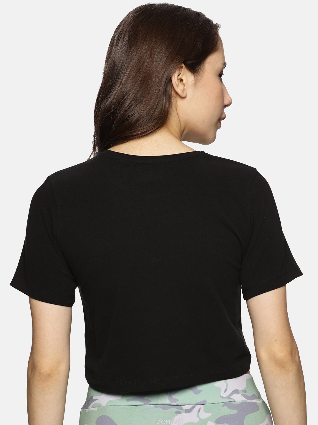 Back view of black cotton spandex crop top, designed for comfort and flexibility."