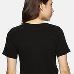 Back view of black cotton spandex crop top, designed for comfort and flexibility."