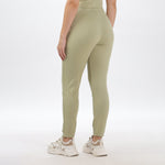 Close-up of light green joggers and crop top fabric, showing soft texture and high-quality stitching.