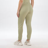 Close-up of light green joggers and crop top fabric, showing soft texture and high-quality stitching.