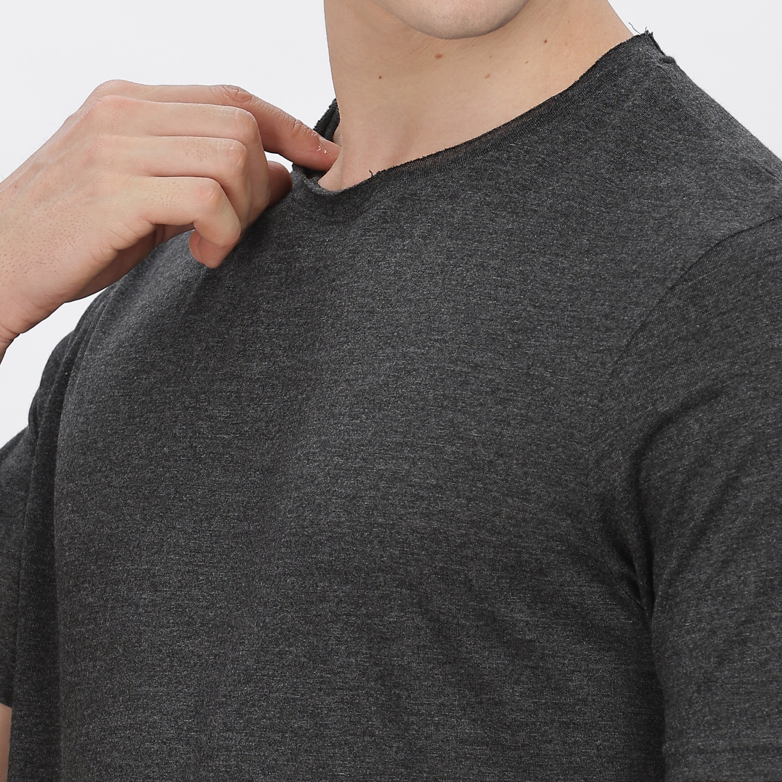 Model wearing a men's grey polyester shirt, styled for both casual and athletic use.