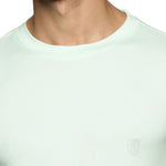 A close-up shot illustrating the soft, cotton-like feel and knitted weave texture of the white polyester fabric.