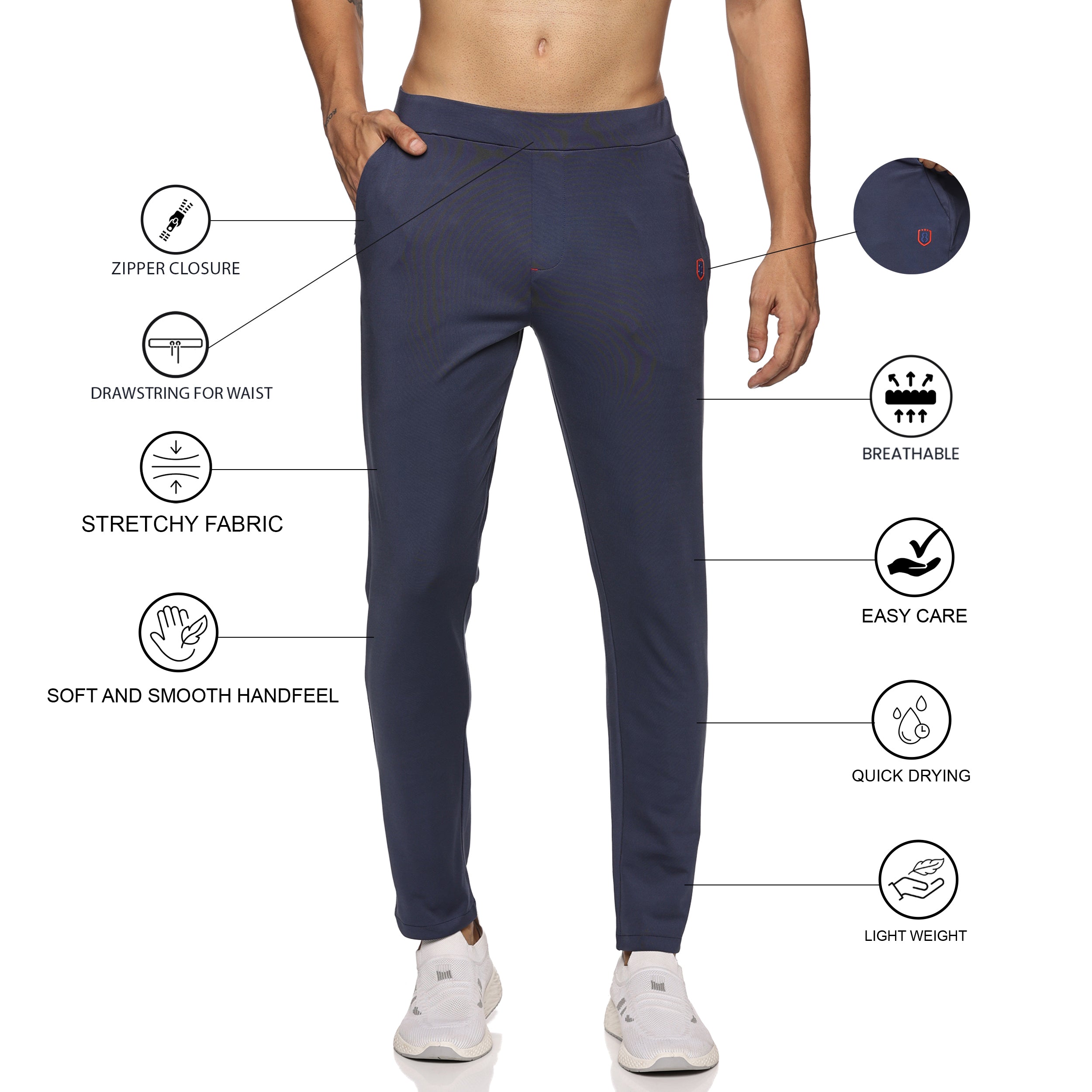 Navy blue track pants for men styled with casual sneakers