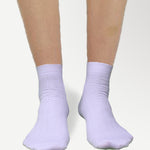 Side view of ankle high nylon white socks, highlighting snug fit and stretchable material.