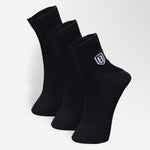 Close-up of black nylon socks, showcasing soft, stretchable fabric and reinforced stitching.
