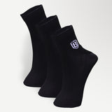 Close-up of black nylon socks, showcasing soft, stretchable fabric and reinforced stitching.