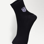 Back view of black nylon socks, featuring durable construction and moisture-wicking material.