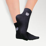 Back view of black high-ankle nylon socks, offering a snug fit and lightweight feel.