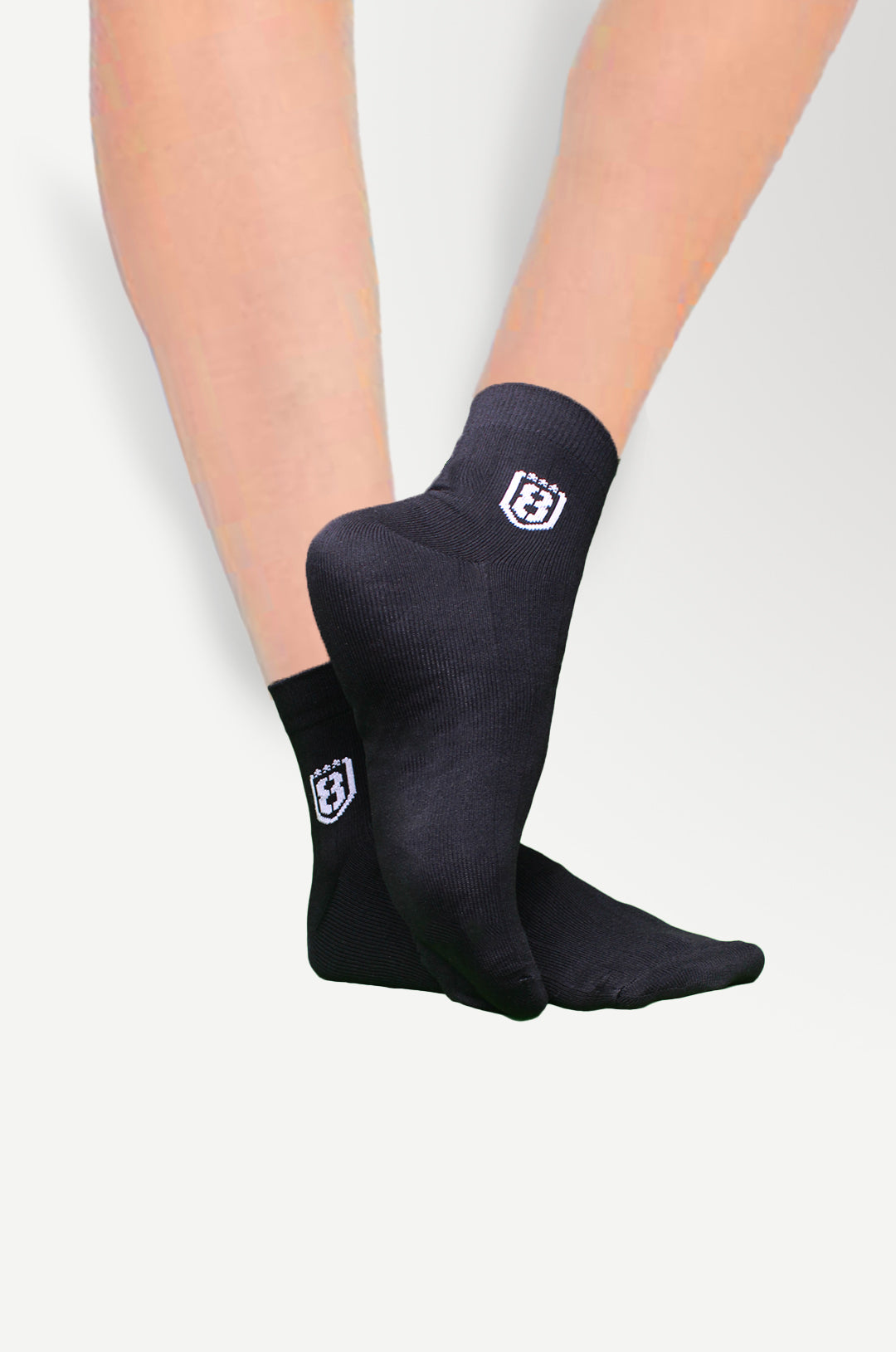 Back view of black high-ankle nylon socks, offering a snug fit and lightweight feel.
