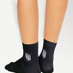 Back view of black nylon socks, featuring durable construction and moisture-wicking material.