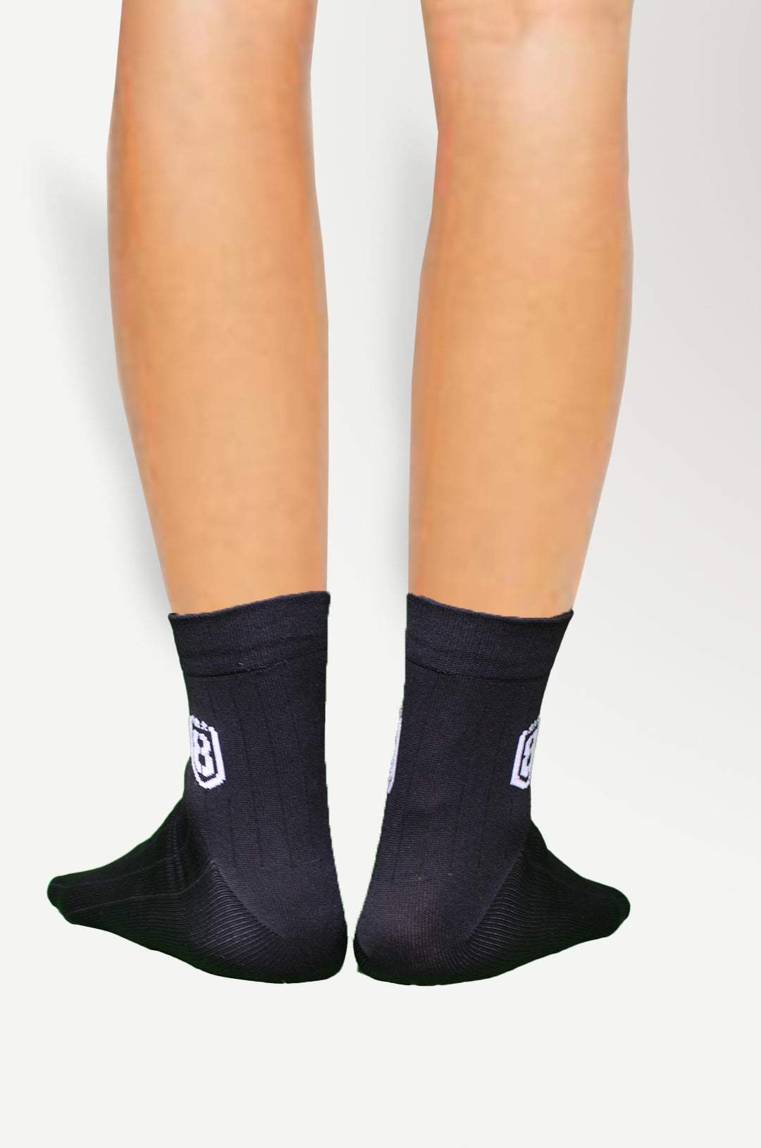 Model wearing black nylon socks, perfect for casual, sports, or everyday use