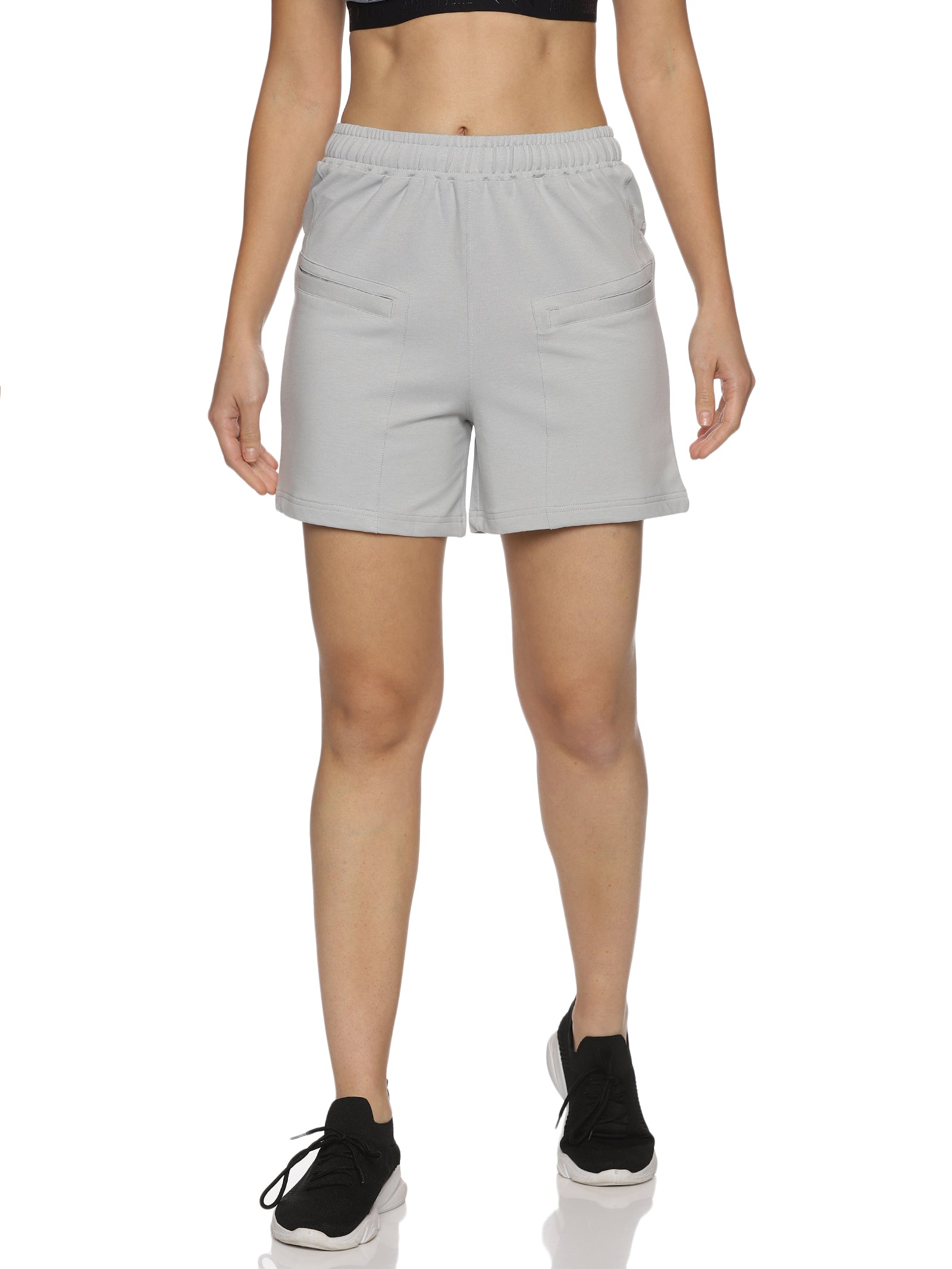 Flat lay of grey sports shorts for women paired with workout accessories.
