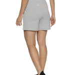 Model stretching in training shorts for women.