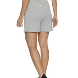Model stretching in training shorts for women.