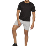 Model running outdoors in men's elastic training shorts.