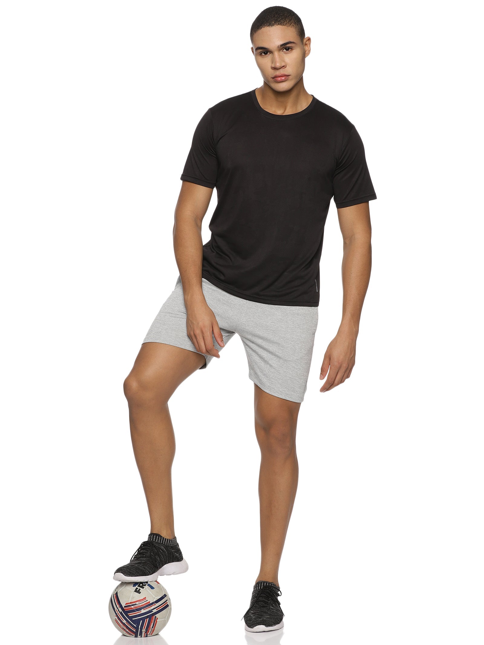 Model running outdoors in men's elastic training shorts.