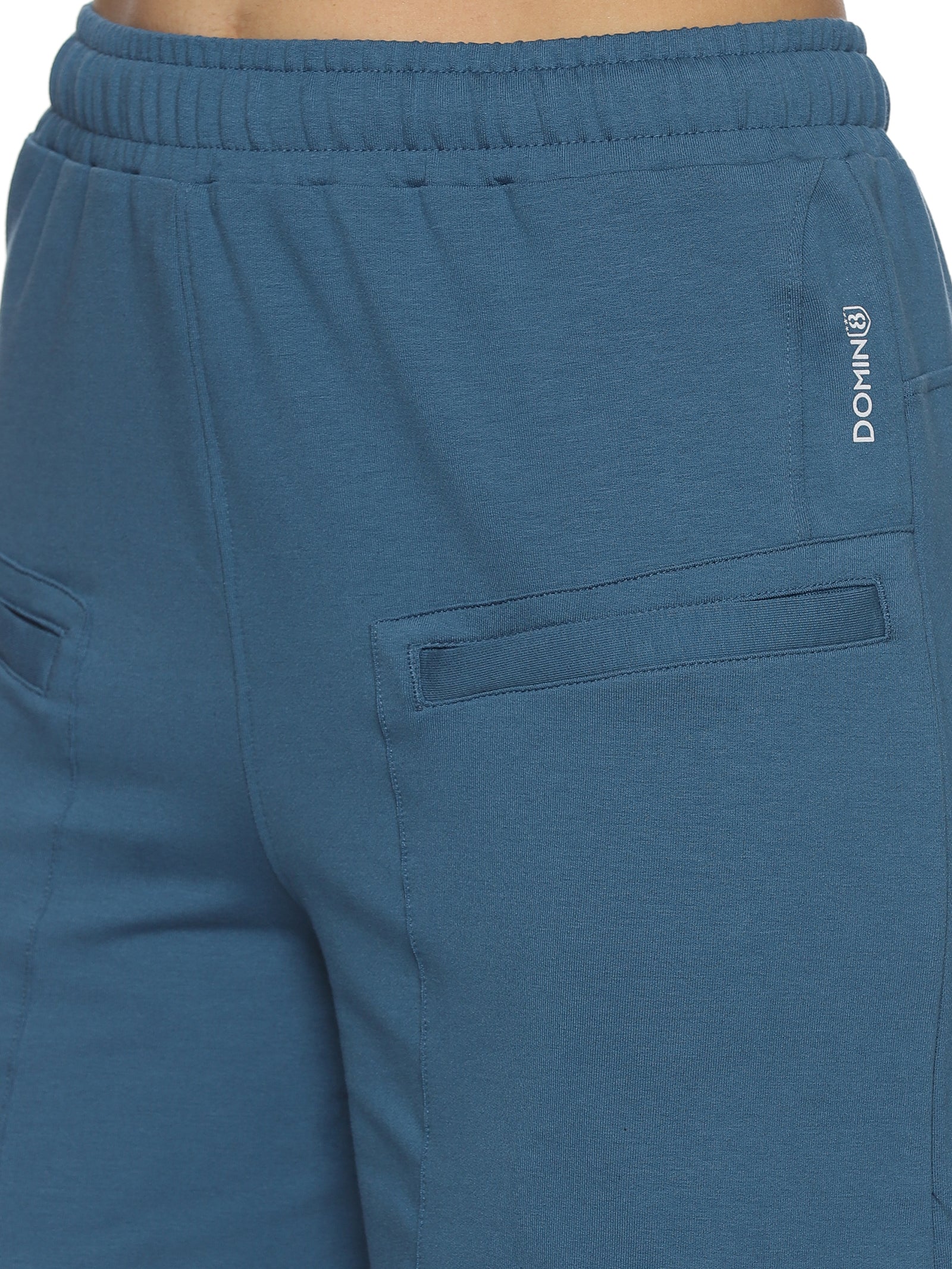 Close-up of breathable fabric and stitching on grey training shorts.
