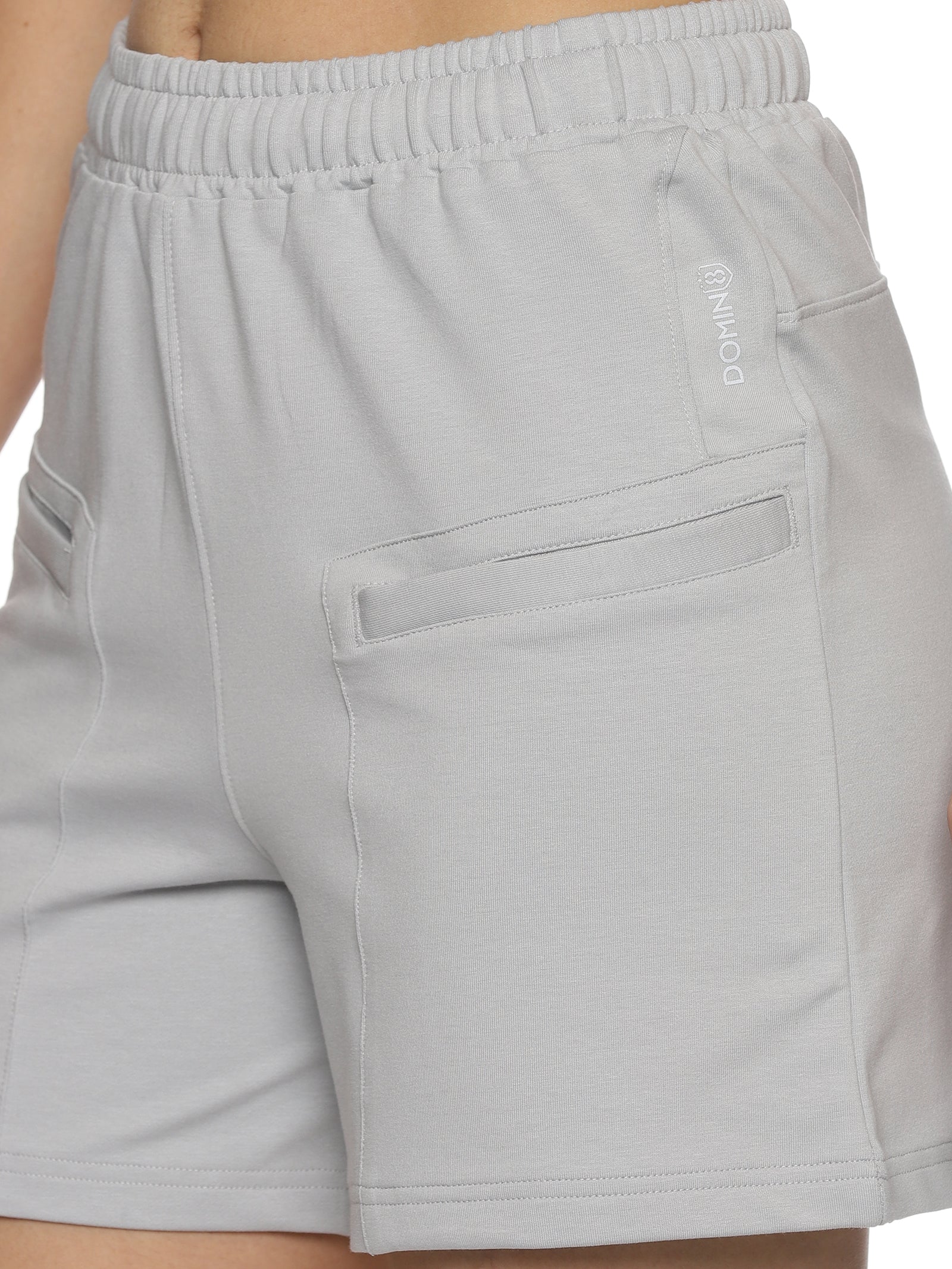 Side profile of women's grey elastic sports shorts for workouts.