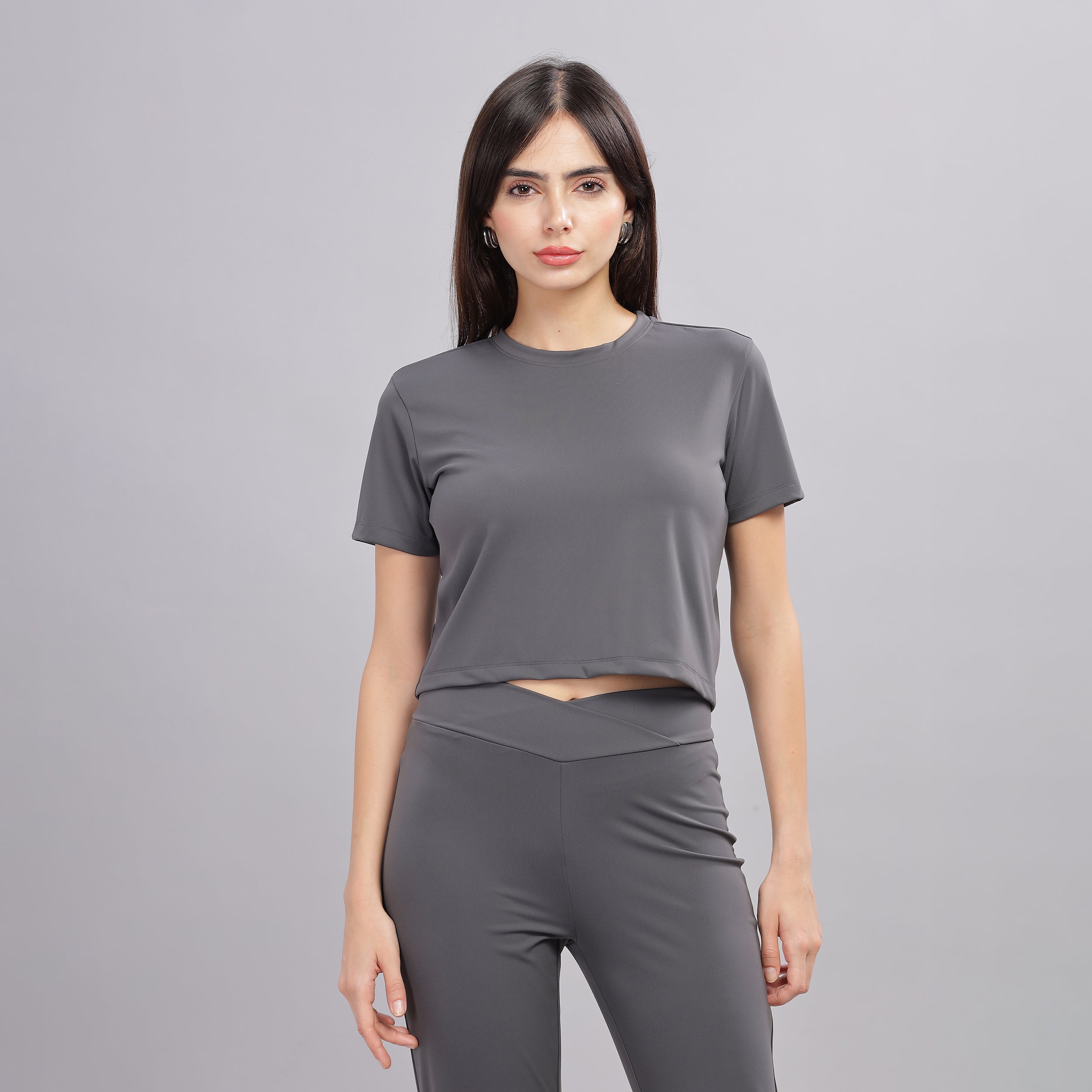 Front view of dark grey crop top and jogger set, women's