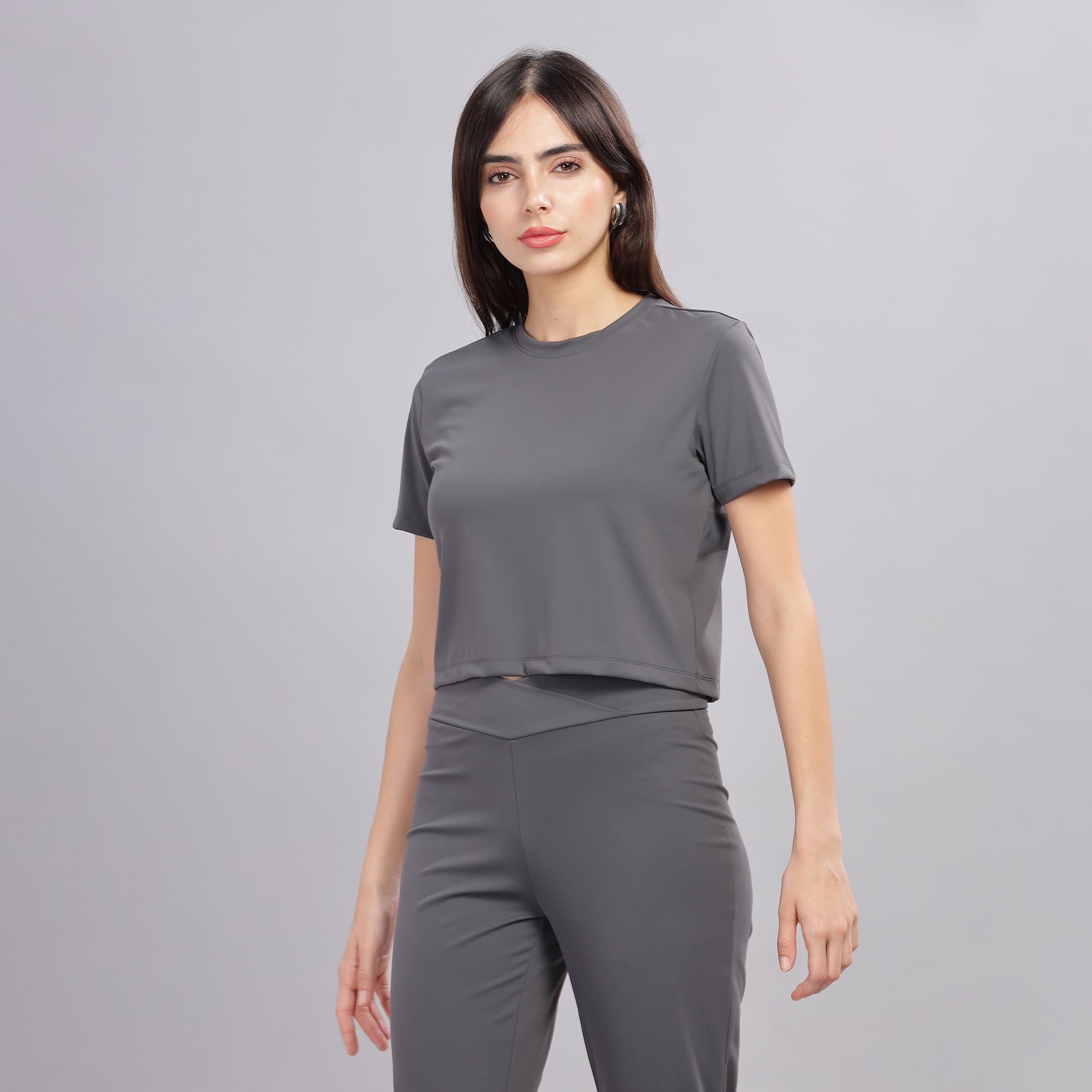 Side profile of slim-fit dark grey crop top and joggers.
