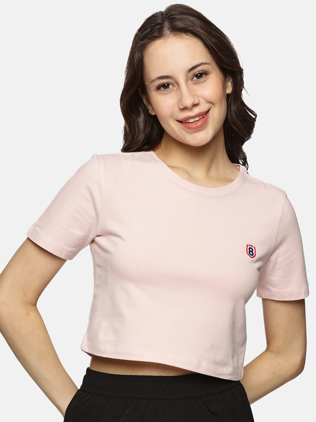 Women’s beige spandex crop top styled for a casual outfit, highlighting versatility and comfort.