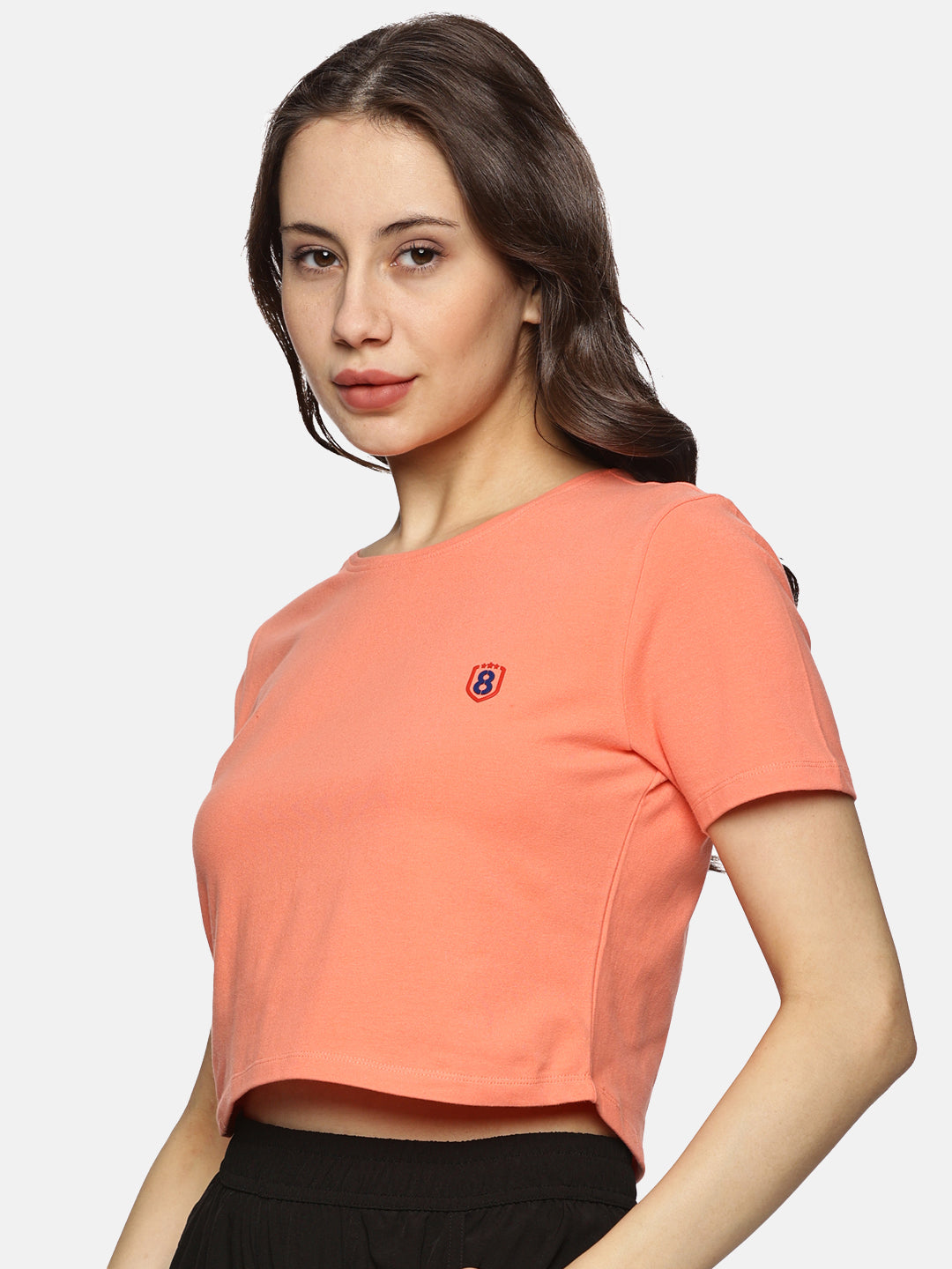 Model wearing a spandex crop top for women, styled with high-waisted leggings for a sporty look