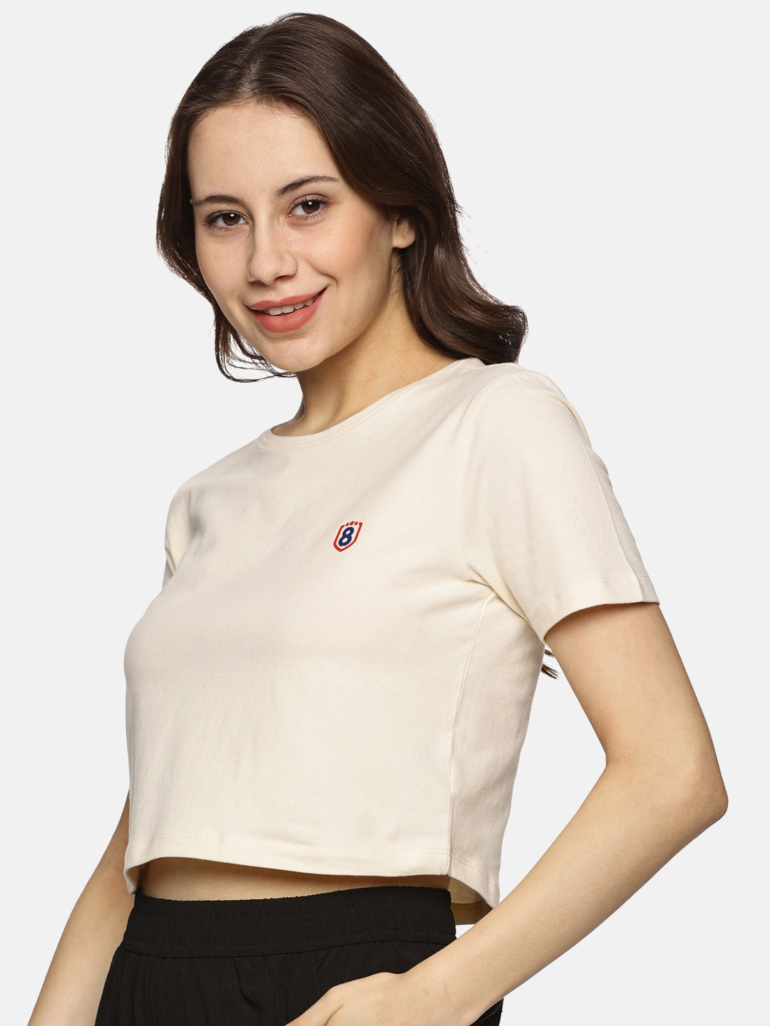 Front view of women’s beige spandex crop top, featuring a snug fit and soft cotton blend fabric.
