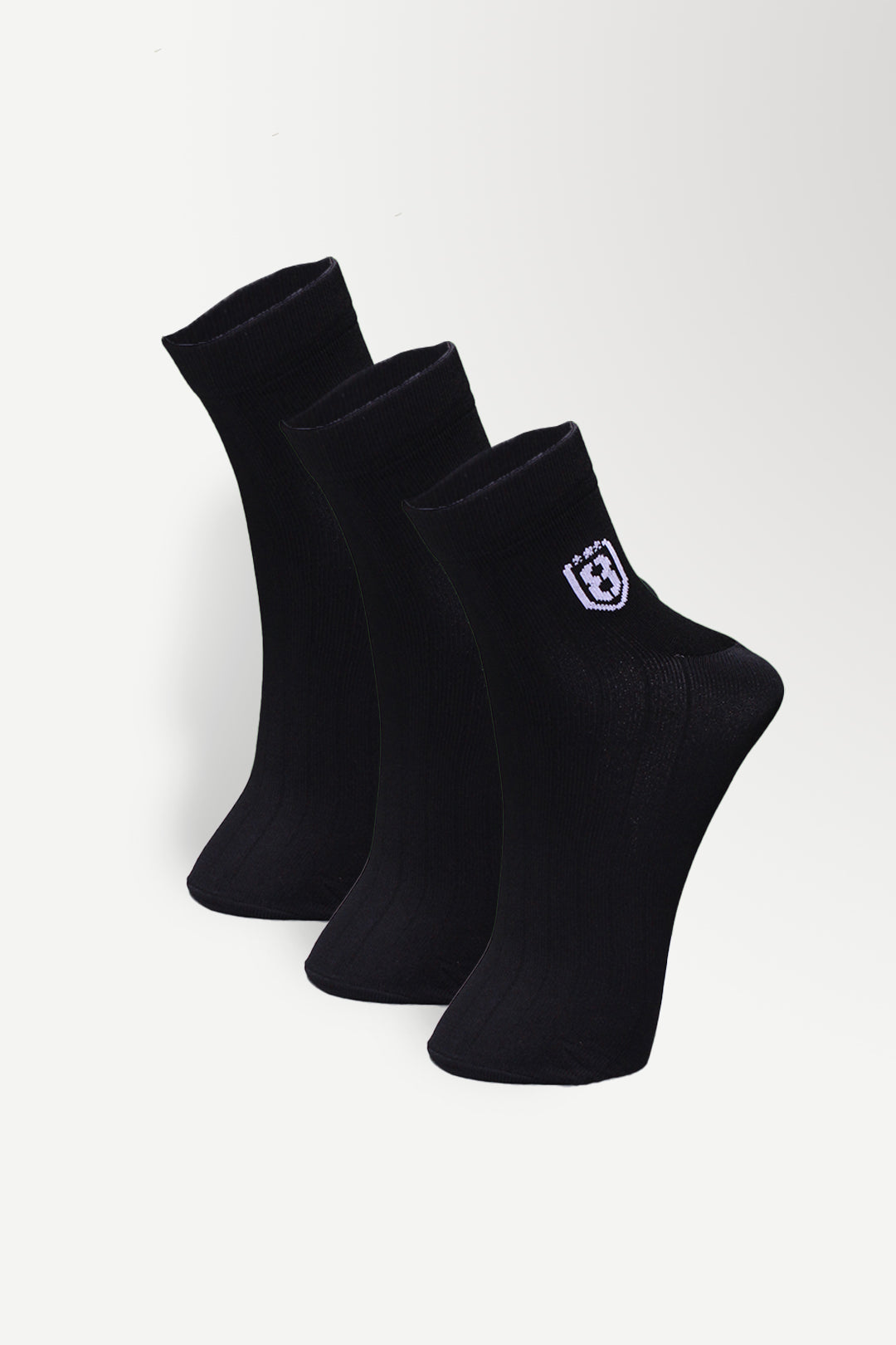 Close-up of black nylon socks, showcasing soft, stretchable fabric and reinforced stitching.