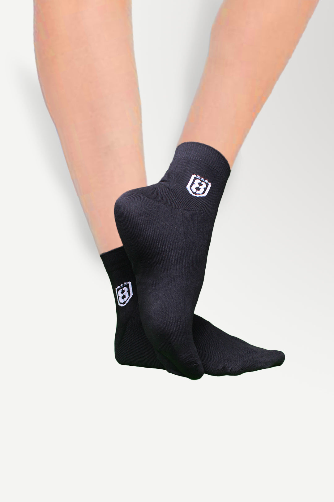Back view of black high-ankle nylon socks, offering a snug fit and lightweight feel.