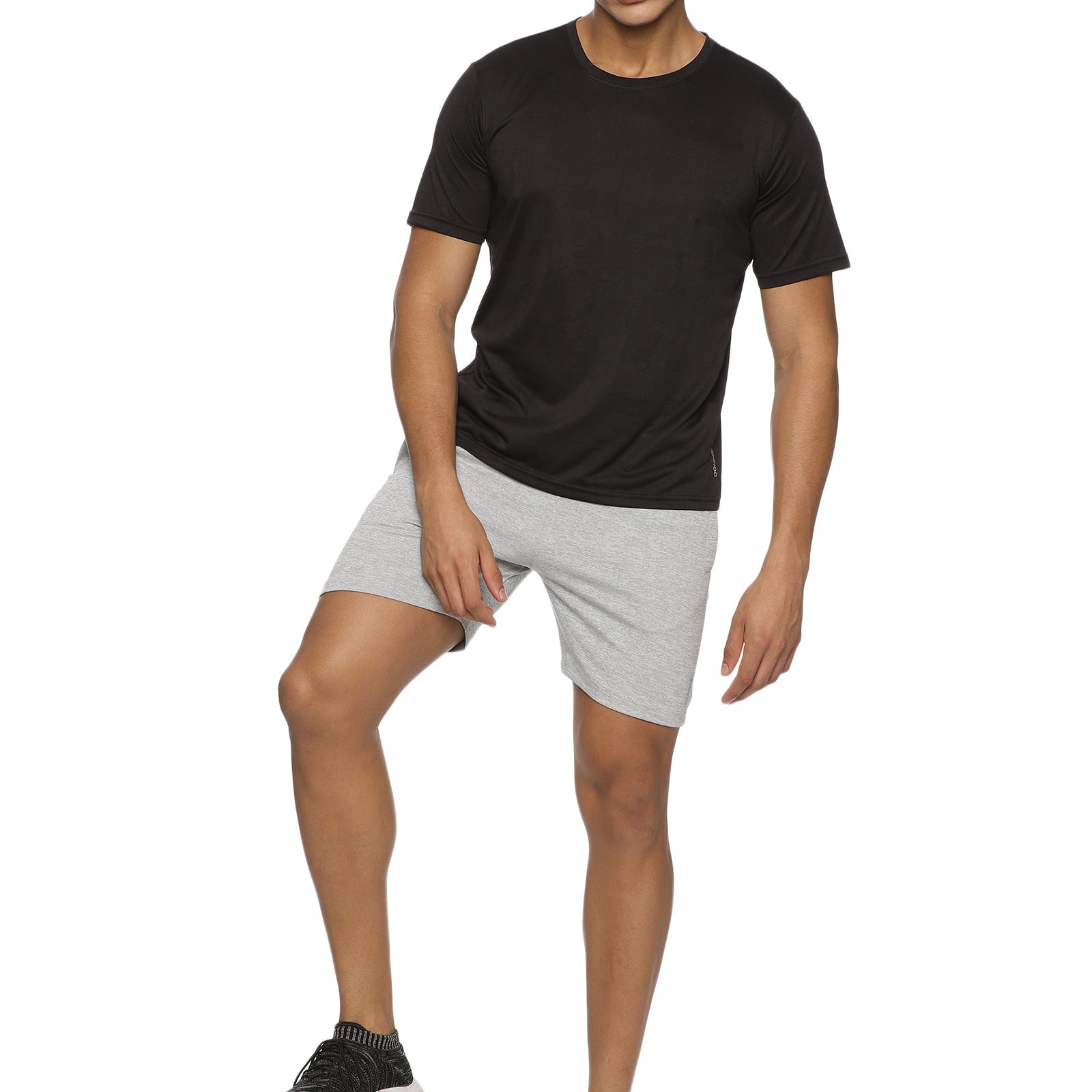 Model running outdoors in men's elastic training shorts.
